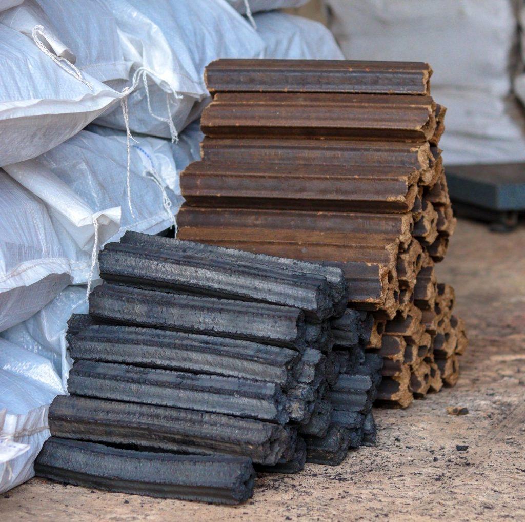 Stacked biomass and charcoal briquettes